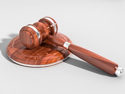 Blog - Wooden Gavel and Sound Block for a Judge on White Background