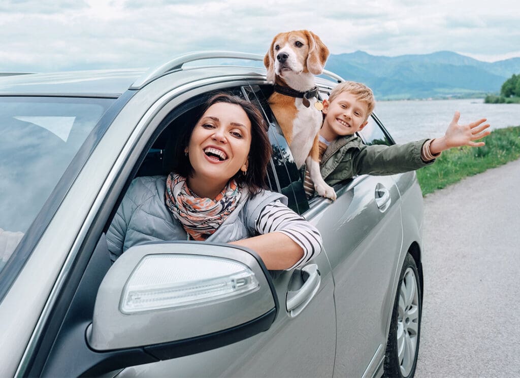 Cheap Car Insurance in Virginia - Happy Family with Dog Look Out from Car Windows