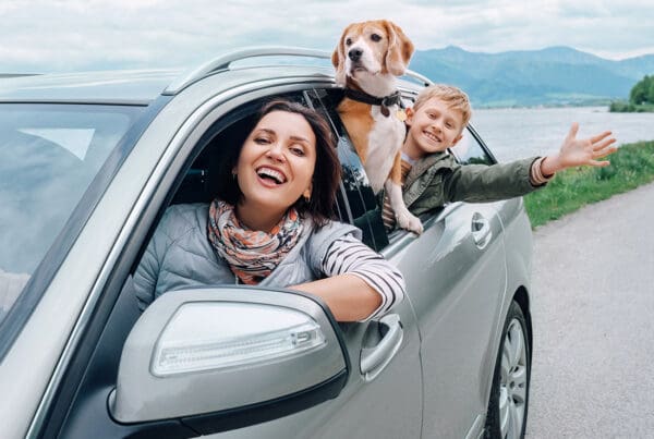 Cheap Car Insurance in Virginia - Happy Family with Dog Look Out from Car Windows