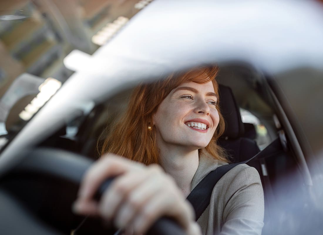 Cheap Car Insurance Maryland - Woman Driving Car and Smiling Close Up of Steering Wheel